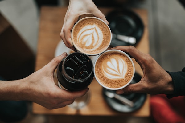 Beautiful fresh green and roasted coffee beans held in hands to showcase sorting and quality